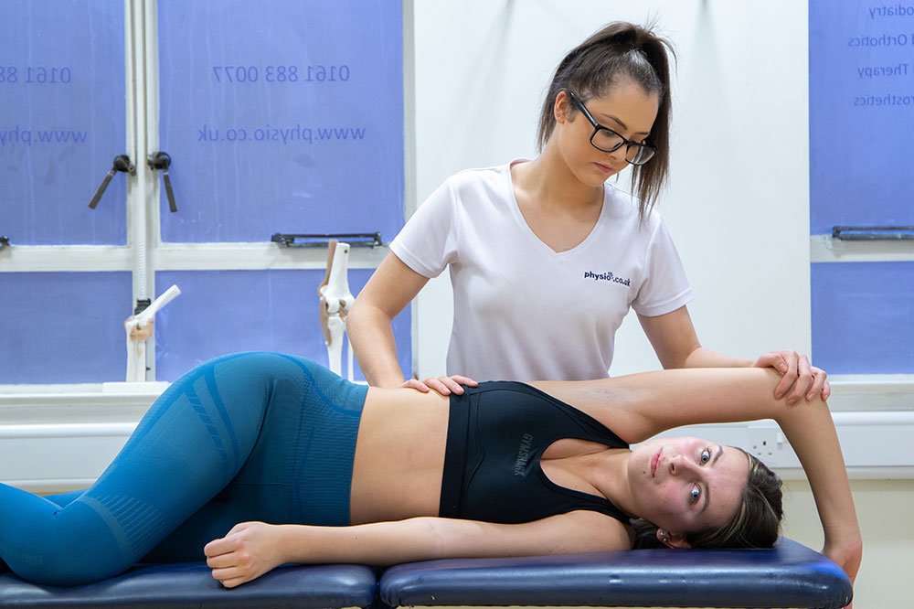 Patient receiving upper body massage in Manchester clinic