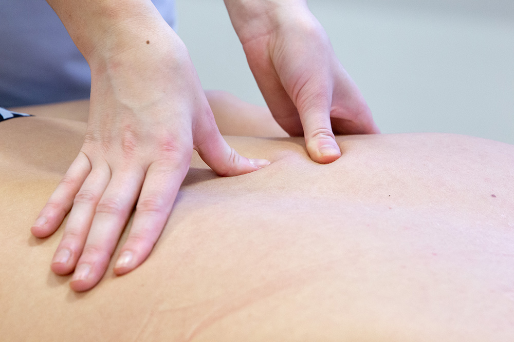 Patient receiving upper back massage in Manchester clinic